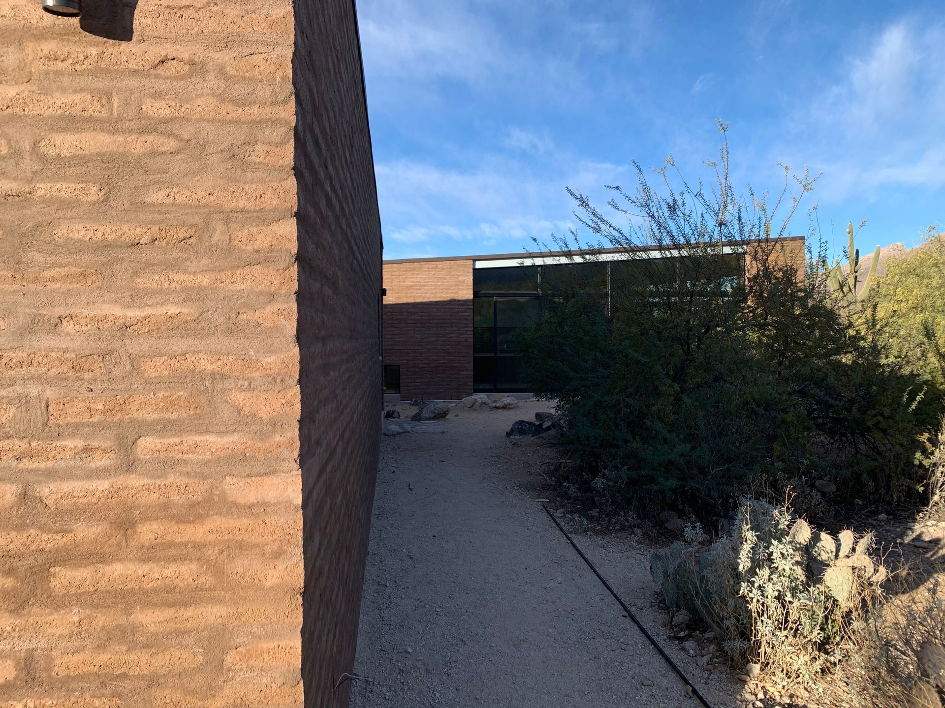 A brick building with a walkway leading to it