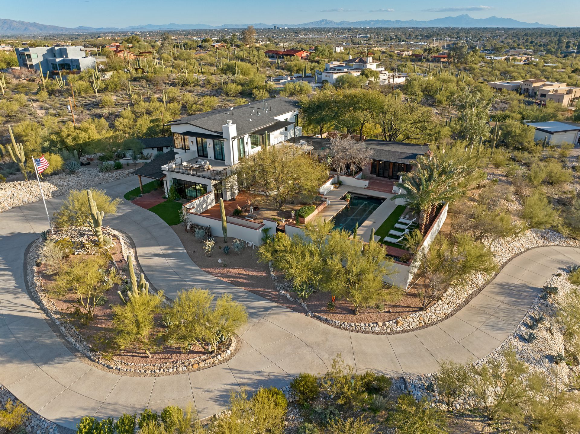 An aerial view of a large house in the middle of a desert.