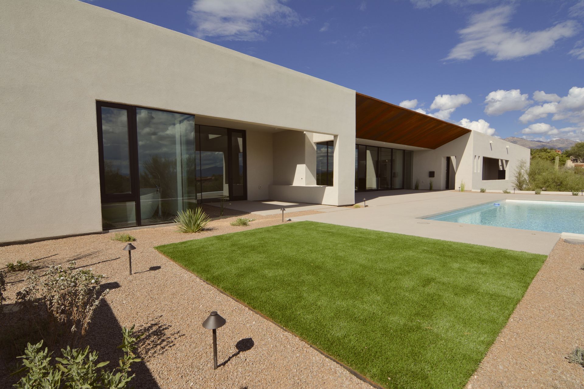 A large house with a swimming pool in the backyard