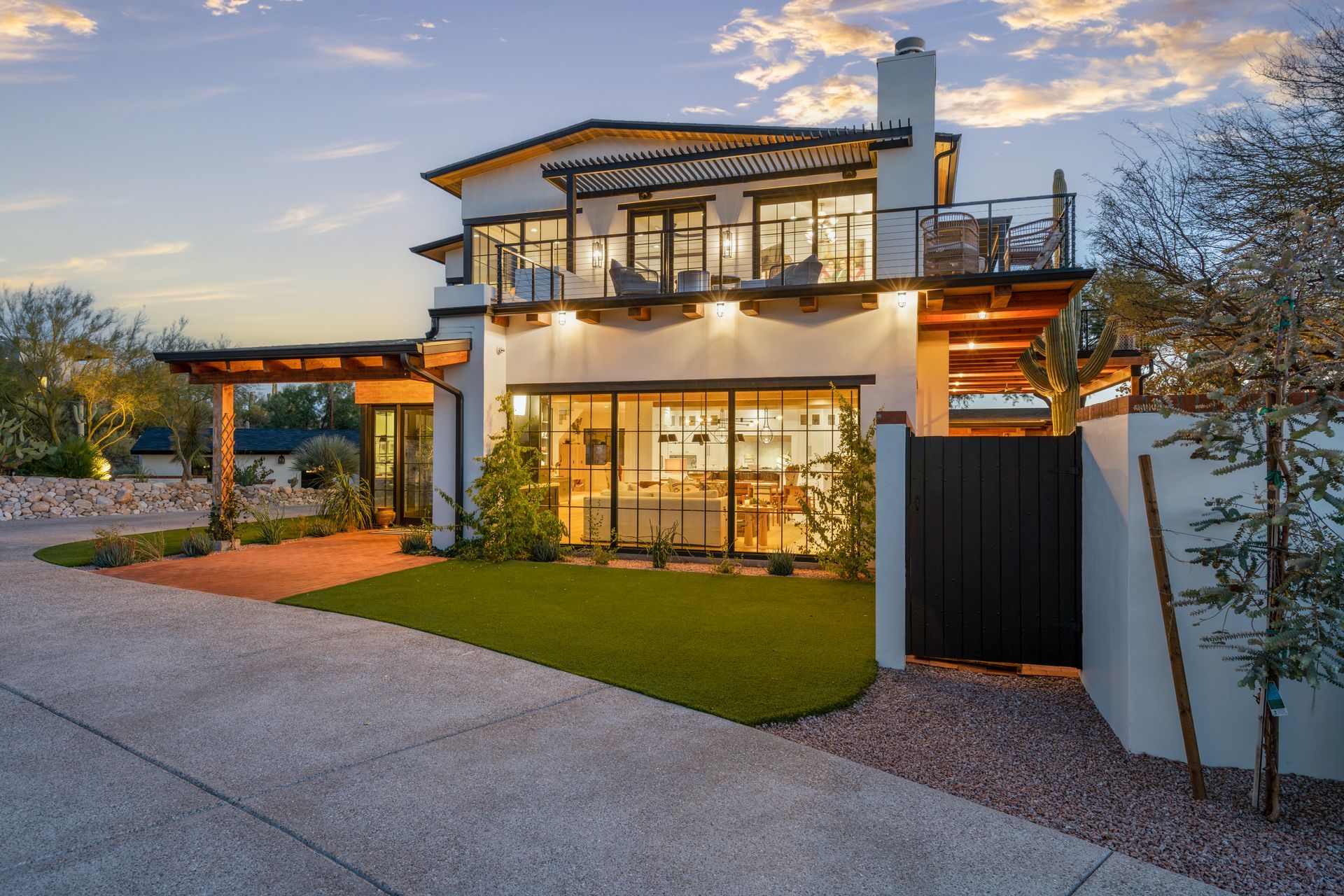 A large white house with a lot of windows and a black gate