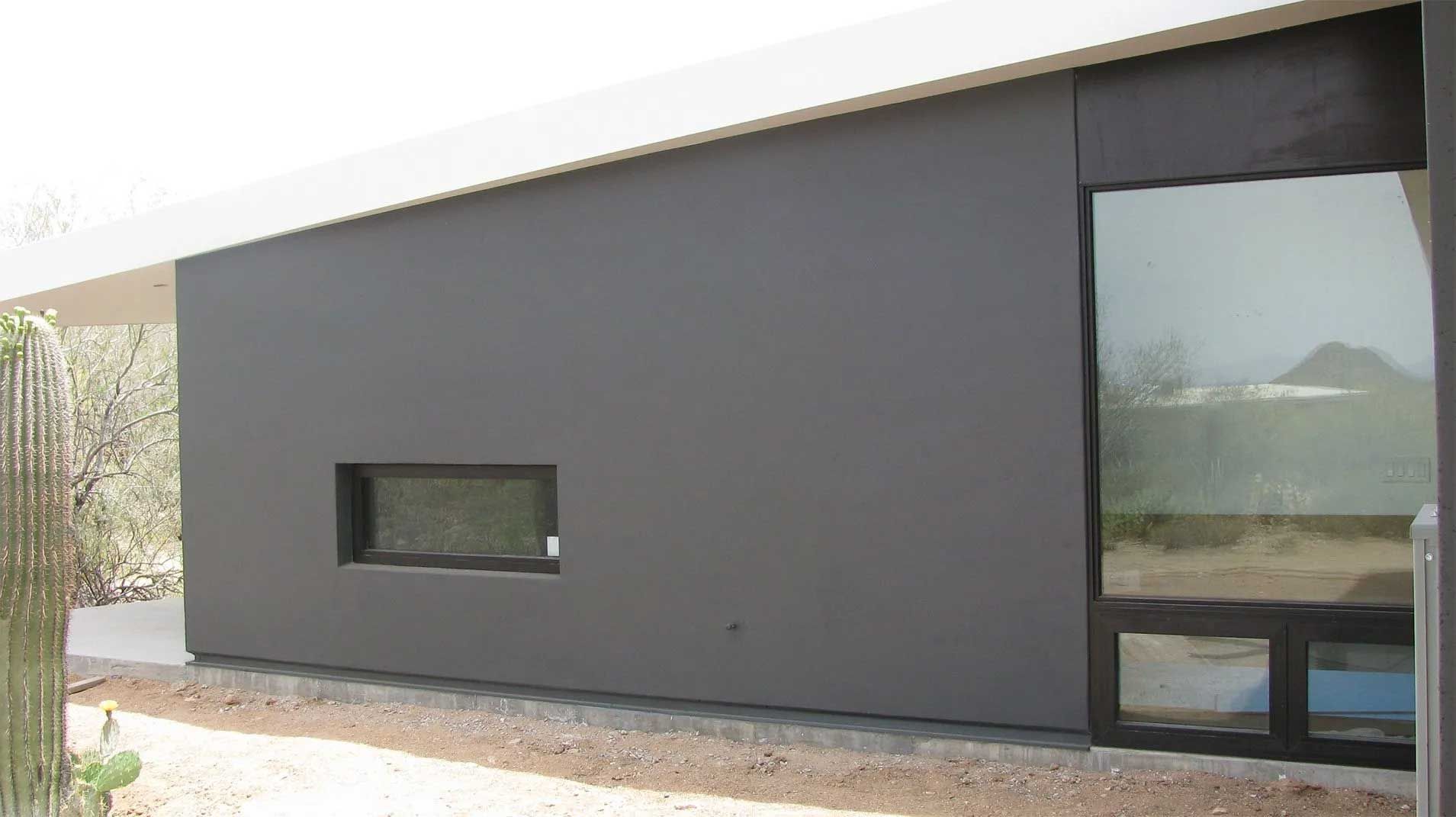 A house with a large window on the side of it.