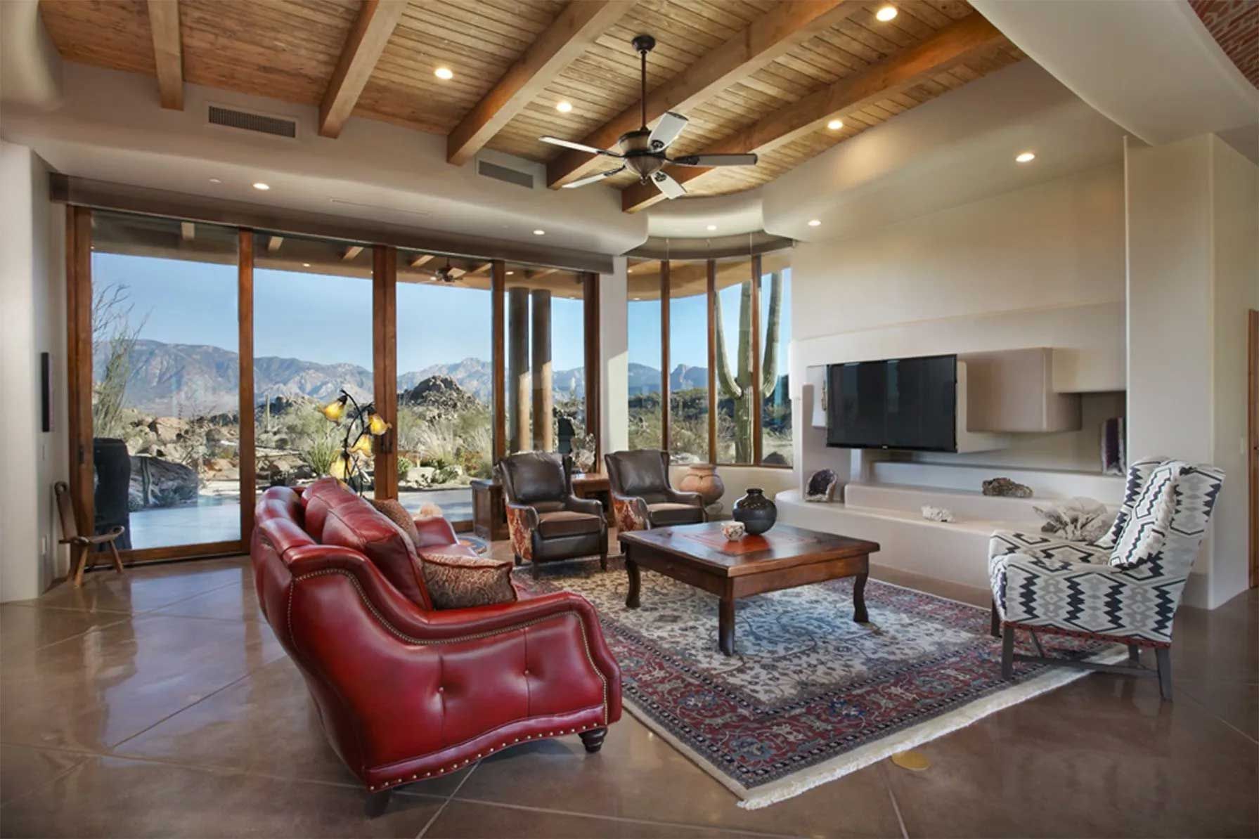 A living room with a lot of furniture and a ceiling fan.