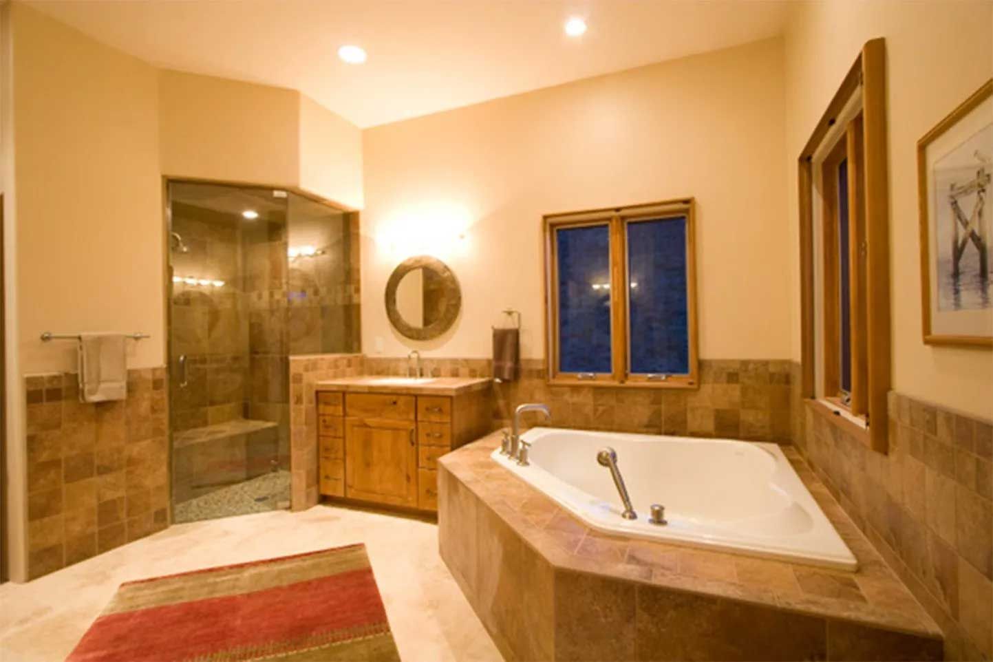 A bathroom with a large tub and a sink
