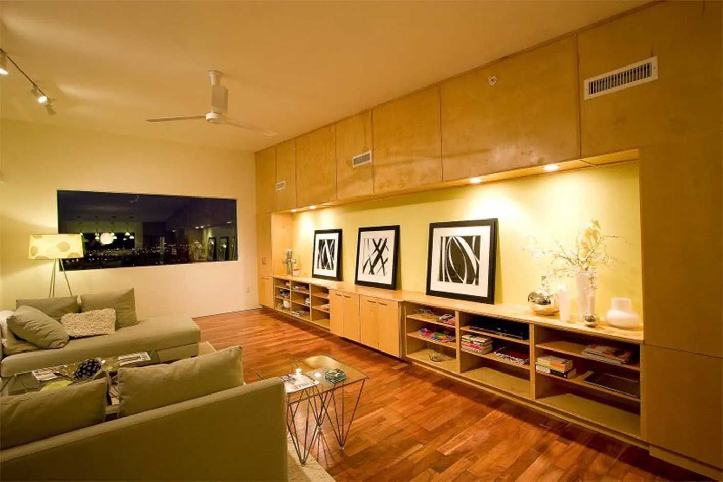 A living room with a lot of furniture and pictures on the wall