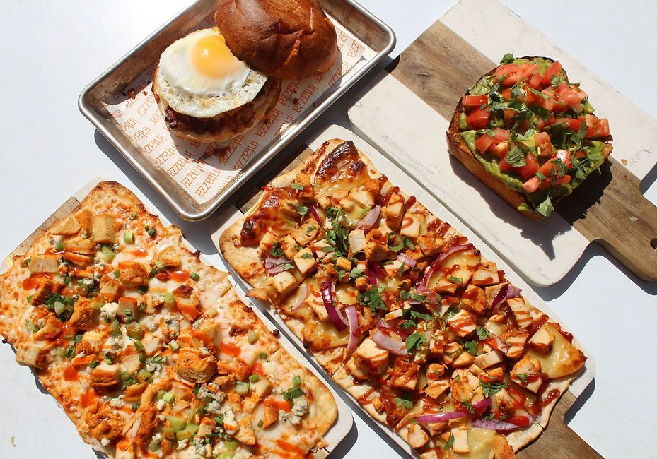 A bunch of different types of food are sitting on a table.