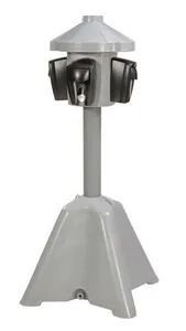 Gray outdoor parking meter pedestal with four covered charging outlets on a central post