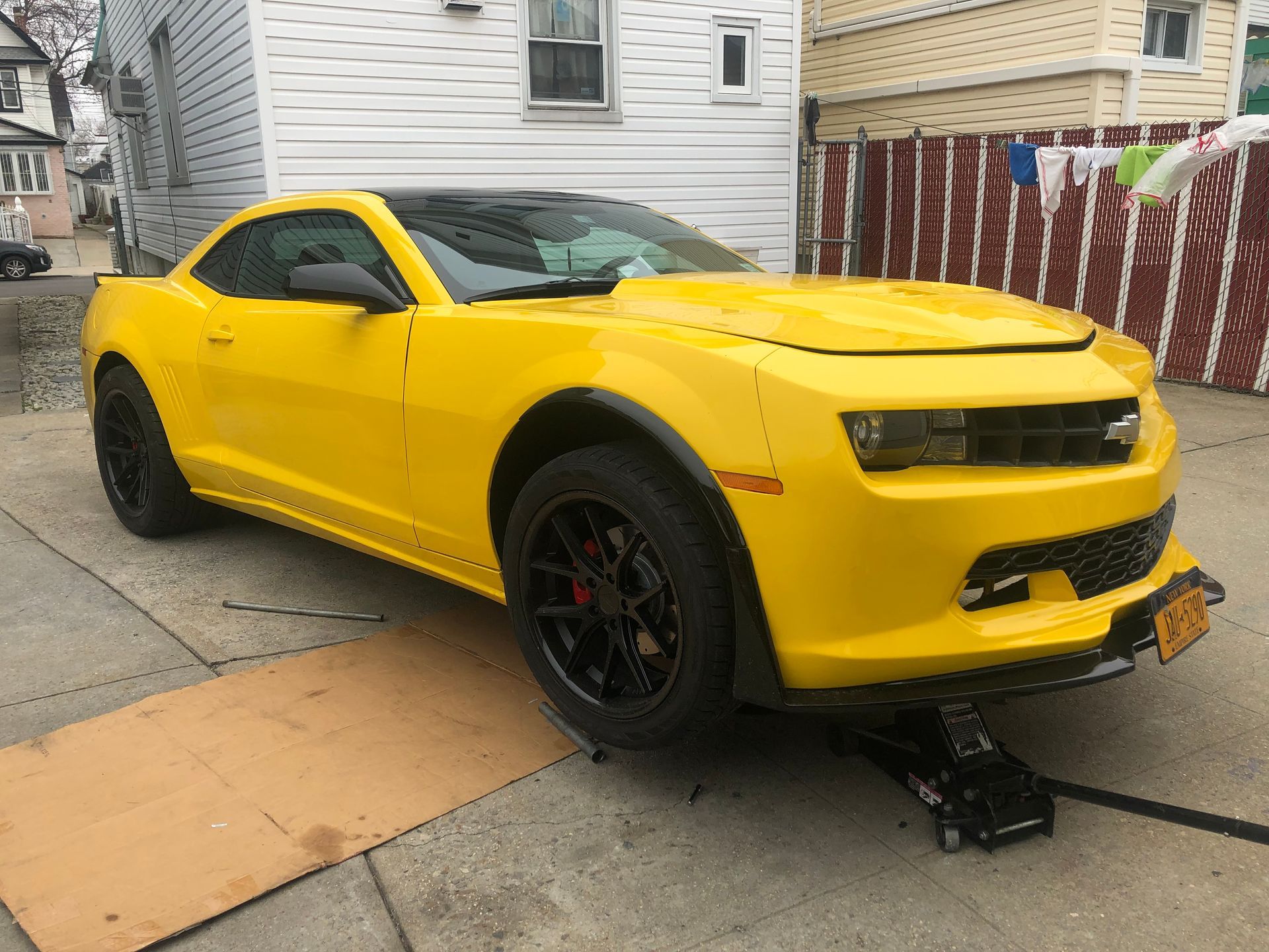 Yellow Chevy Camaro, front tire off the ground