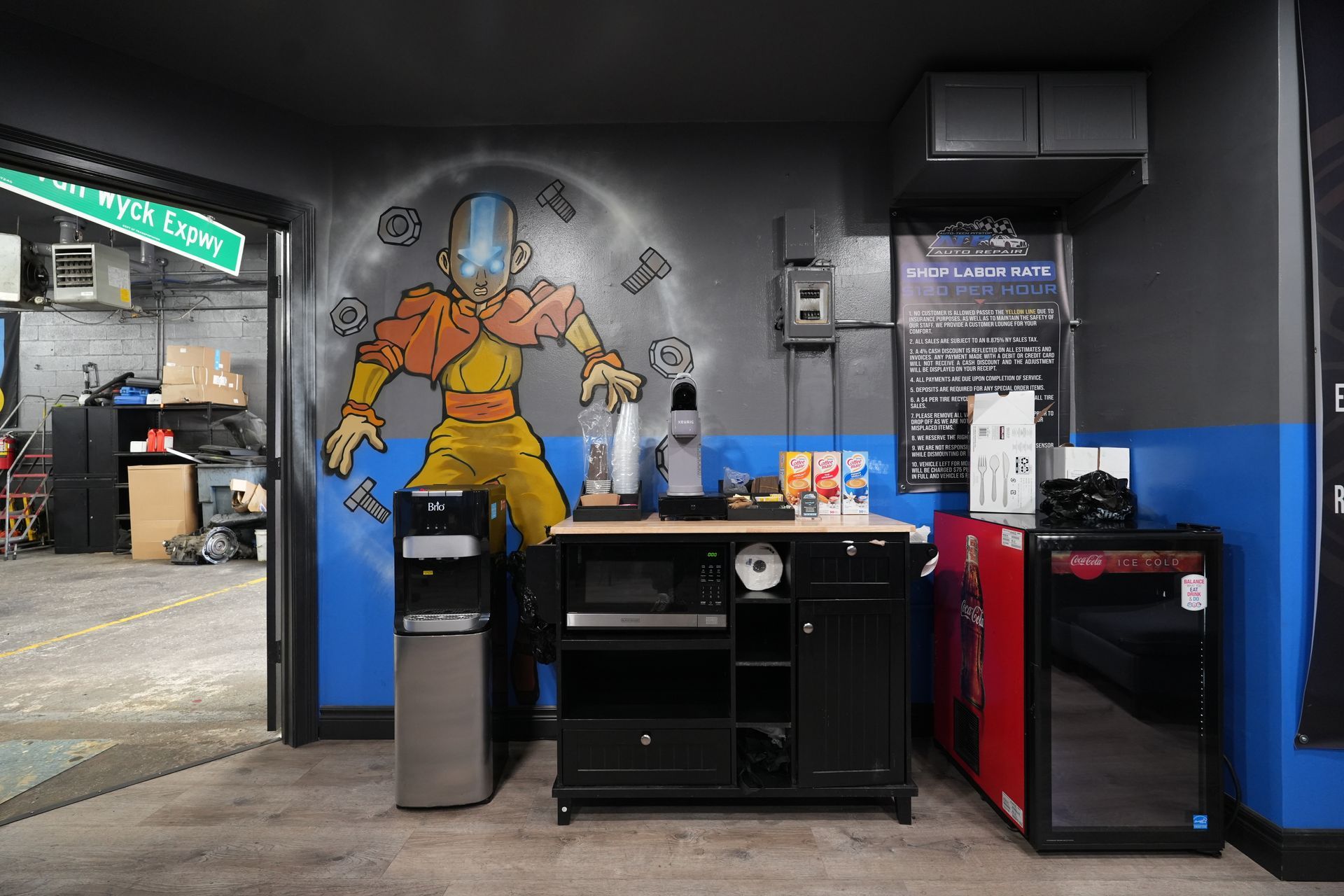 A room with a painting of a man on the wall.