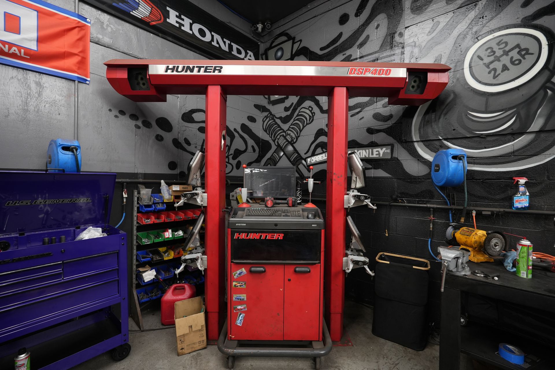 A red hunter alignment machine is sitting in a garage.