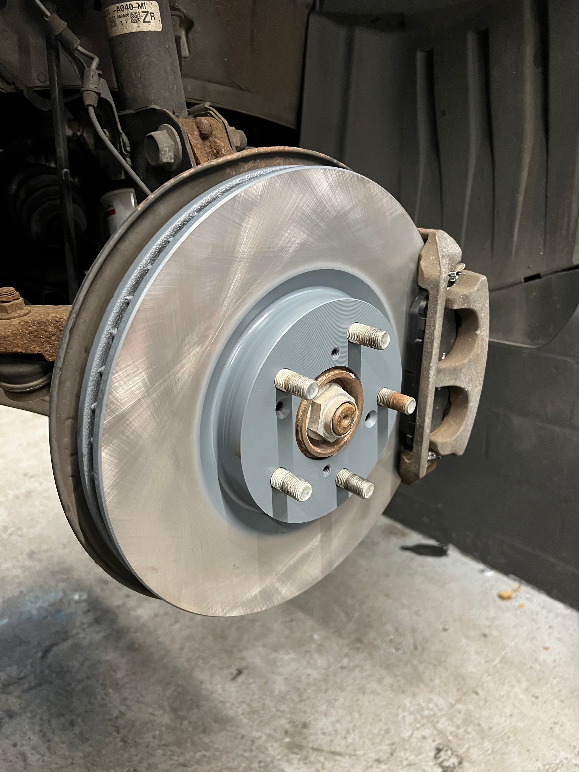 A close up of a brake disc on a car.