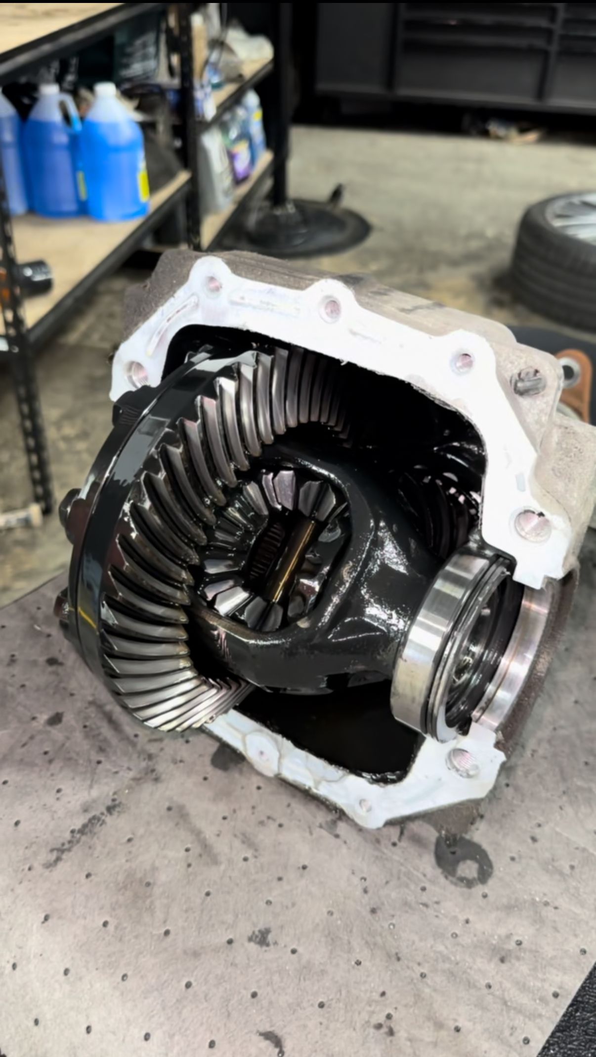 A gearbox is sitting on a table in a garage.