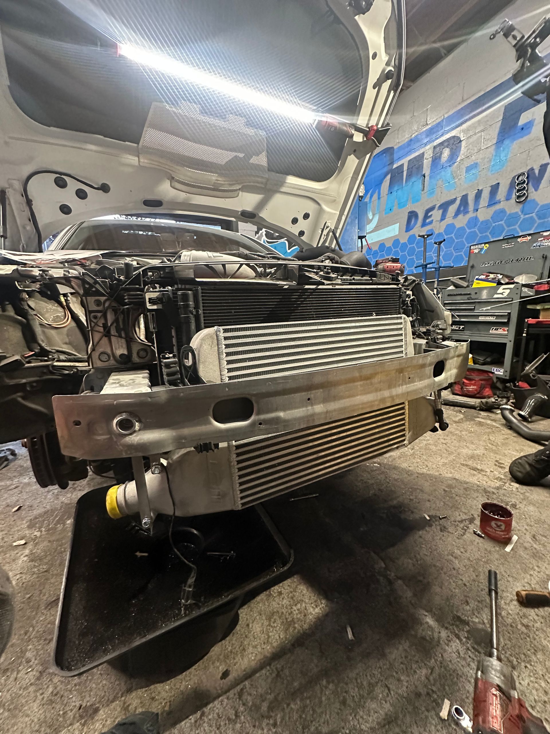 A car is being worked on in a garage.