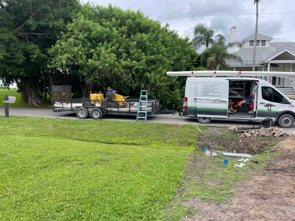 A van is parked on the side of the road next to a trailer.