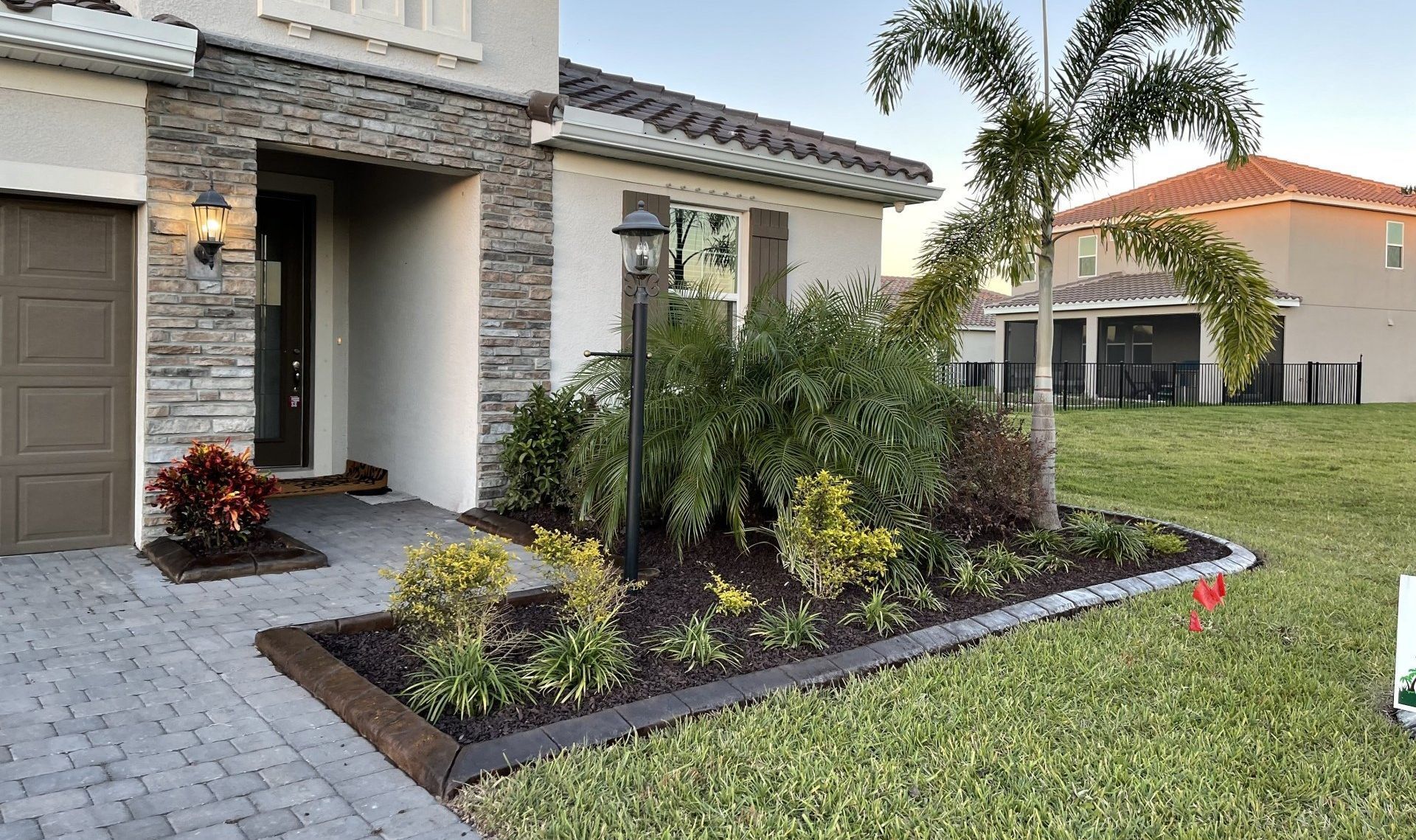 A house with a lot of plants in front of it