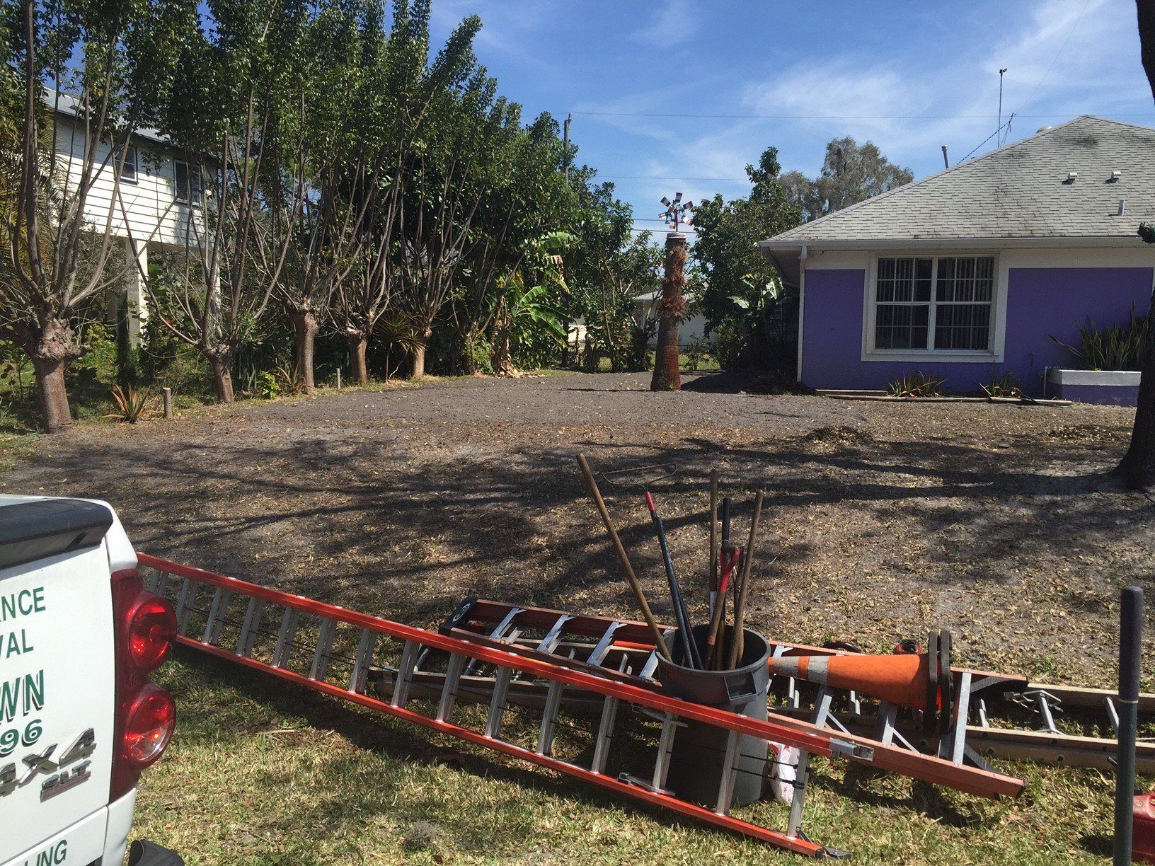 A purple house with a white truck parked in front of it