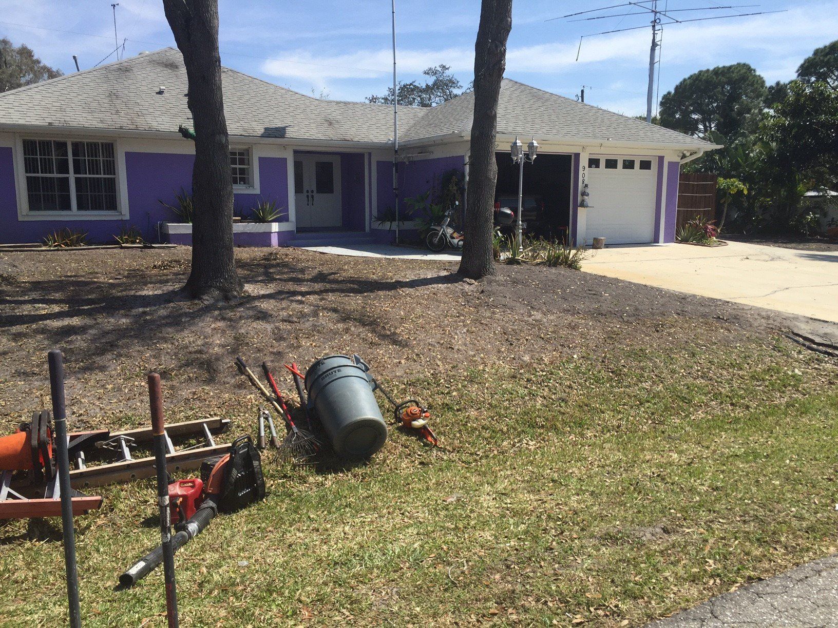 A purple house with tools in front of it