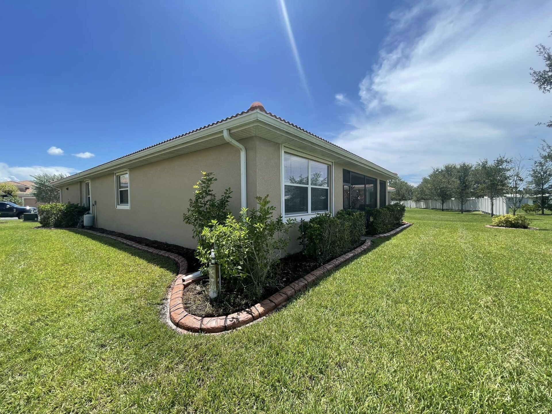 A house with a large lawn in front of it.