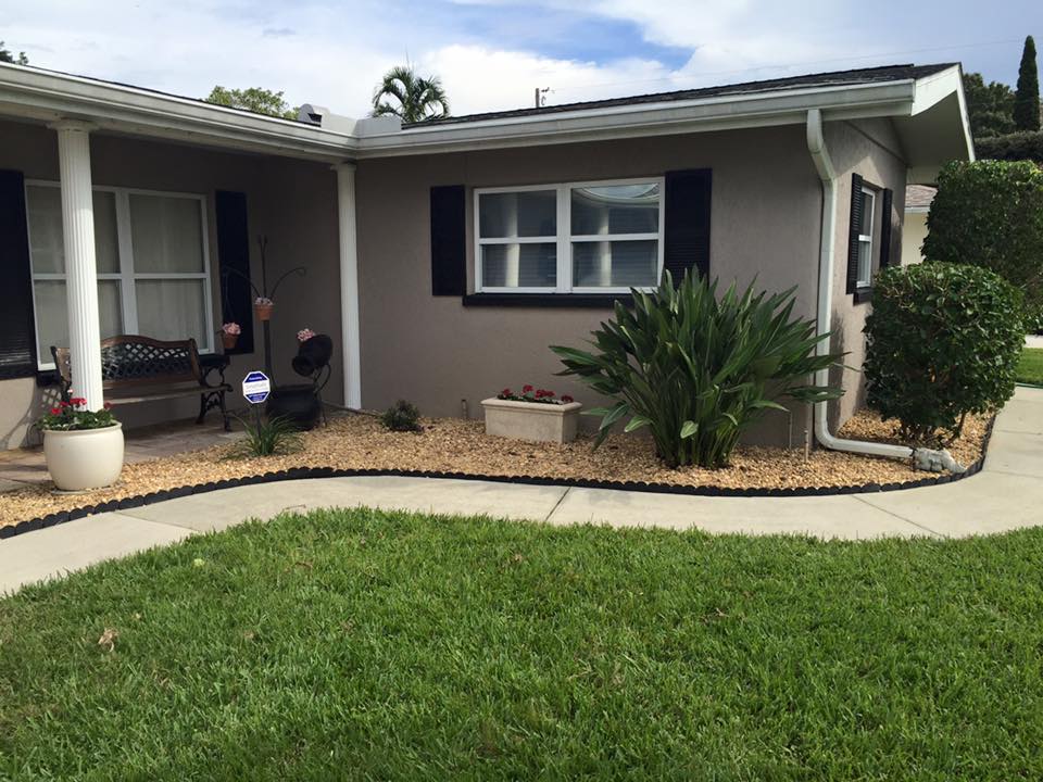 A house with a porch and a walkway leading to it