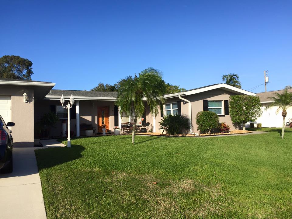 A house with a car parked in front of it