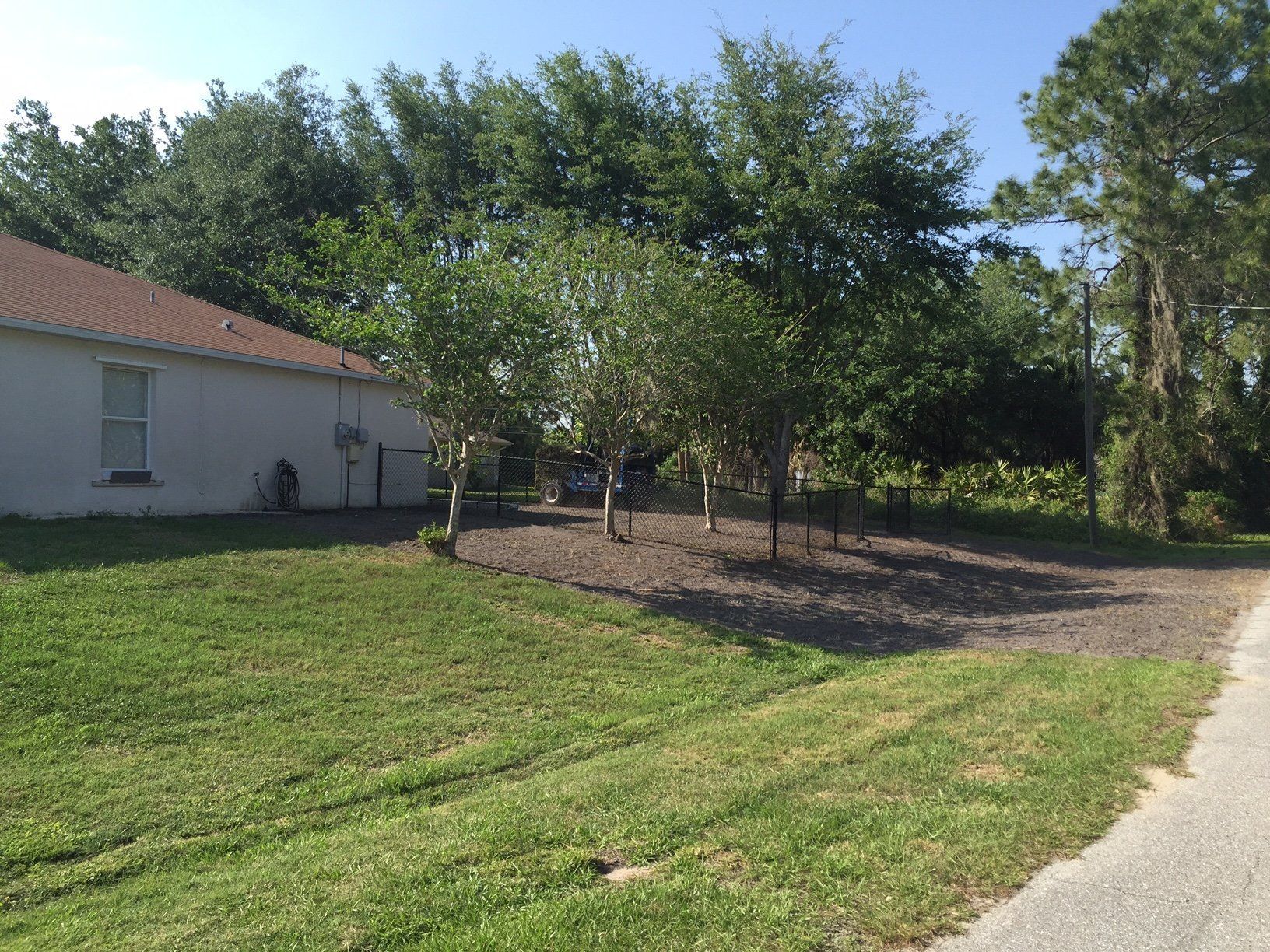 A house with a lot of grass and trees in front of it