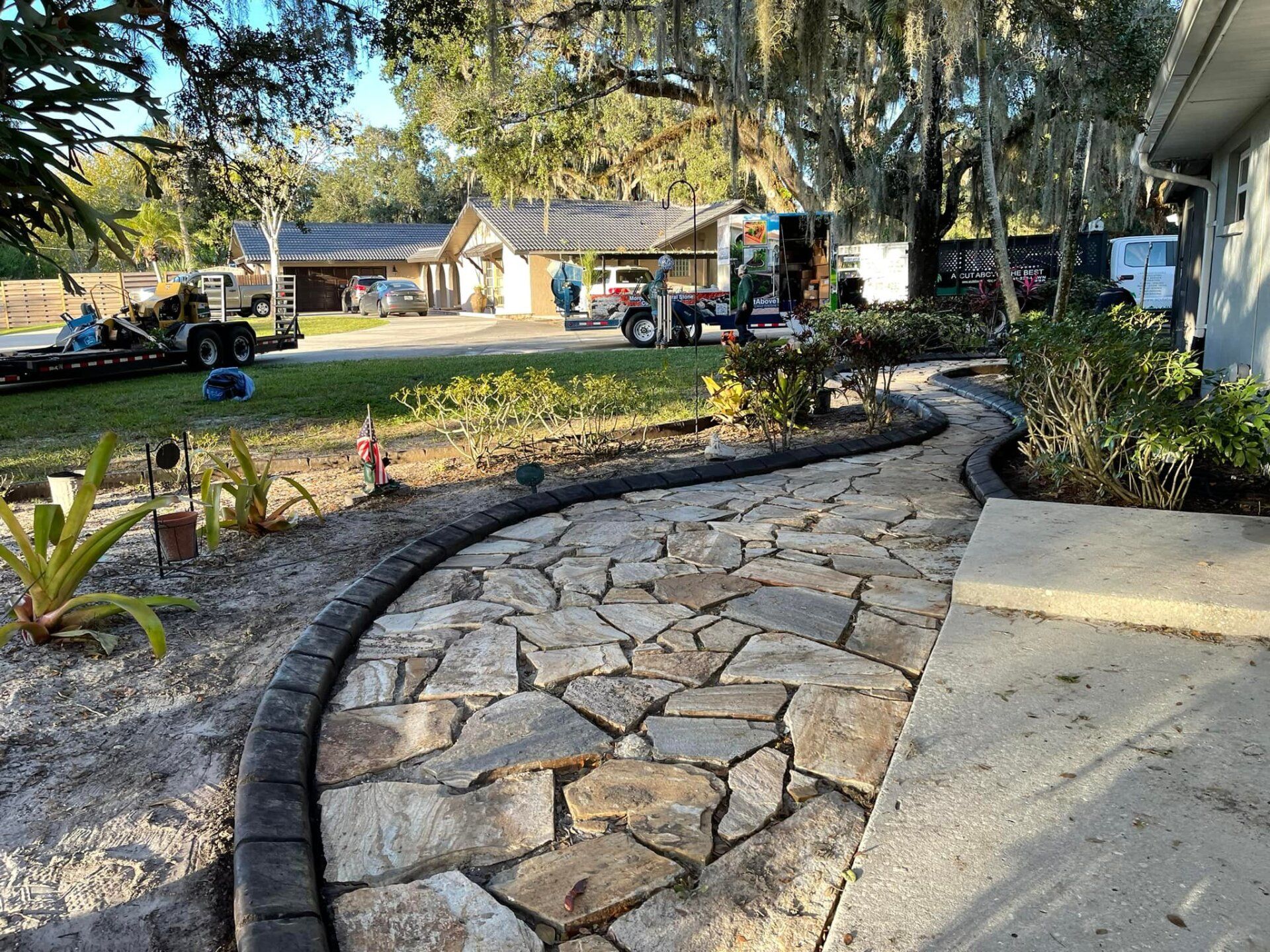 A stone walkway is being built in front of a house.
