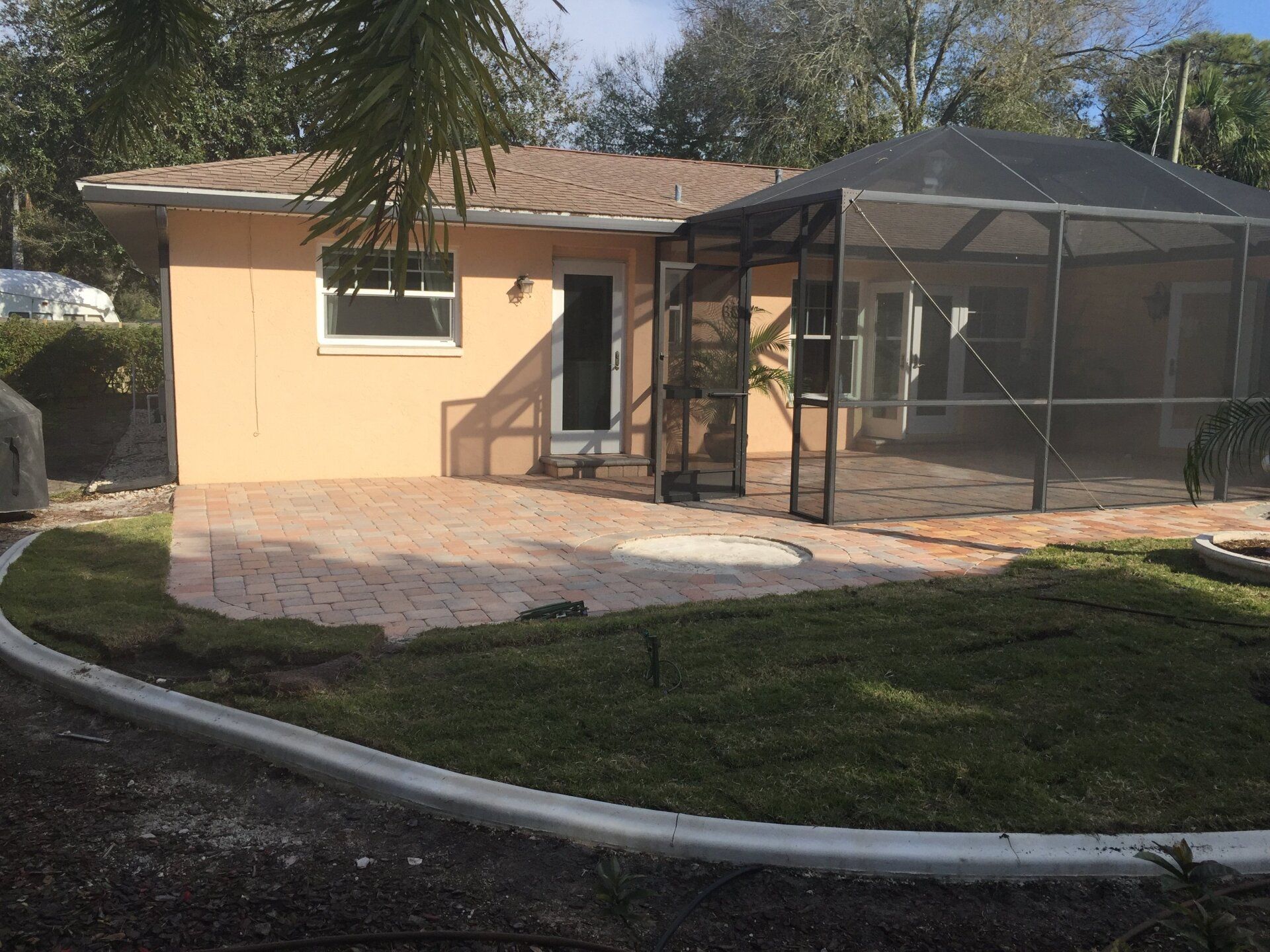 A house with a screened in porch and patio