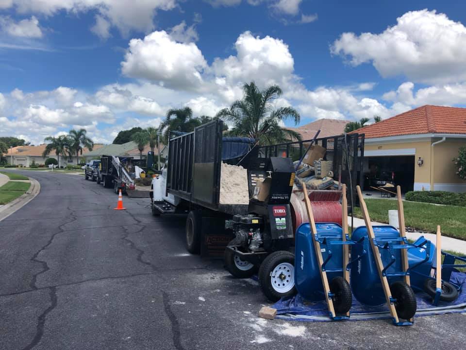 A truck is parked on the side of the road next to a house.