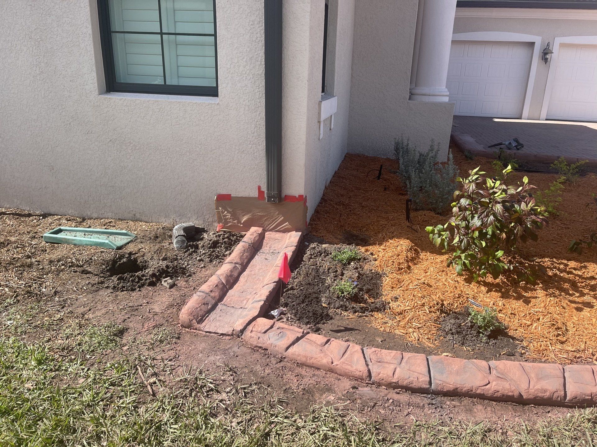 A brick walkway is being built in front of a house.