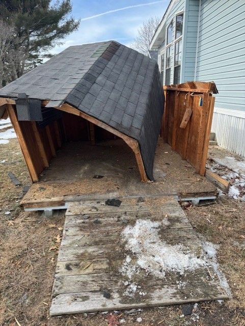 A shed with a roof that has fallen off of it.