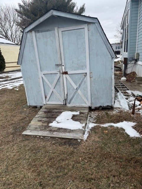 A small shed with a ramp in front of a house