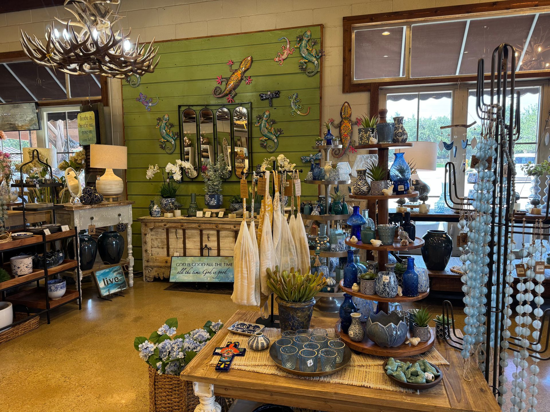 Blue and coastal-themed pottery (vases, bowls, and planters), Ceramic lizards and wall art, Mirrors with rustic wood frames, Multitiered wood display stands, Beaded garlands and tassel décor, Decorative crosses and trinket dishes, Tabletop lamps with neutral shades, Succulent arrangements and faux plants,