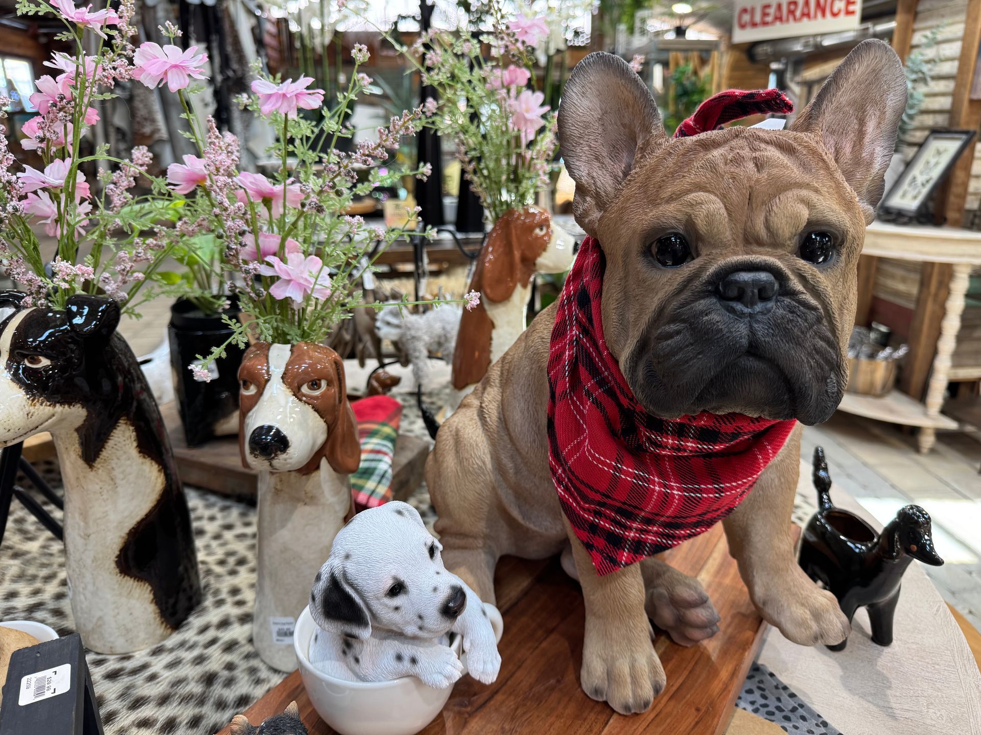 Dog decor display. Dog bandanas, figurines, pots, stones.