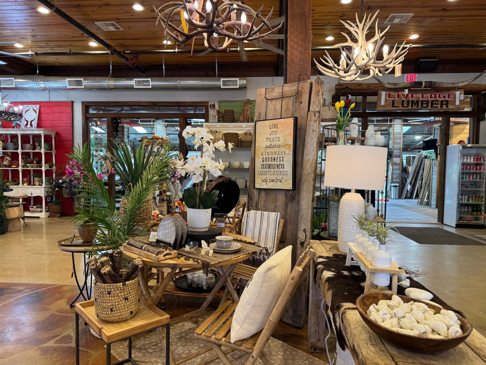 Antler chandeliers, White textured table lamp, Tall rustic wood board with inspirational sign (