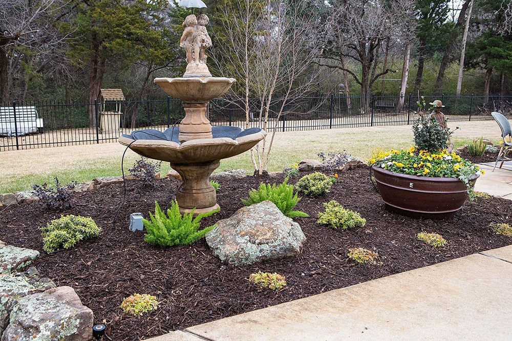 a fountain in the middle of the garden