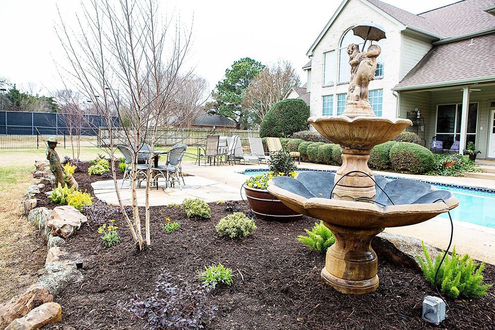 fountain in the middle of a backyard