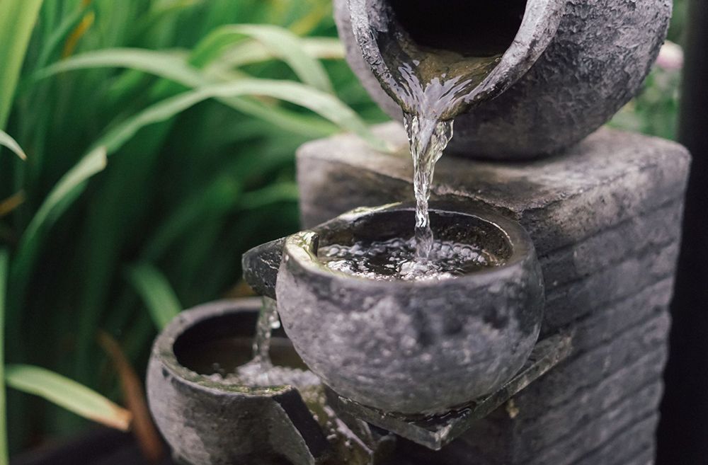 A close up of a water fountain with water pouring