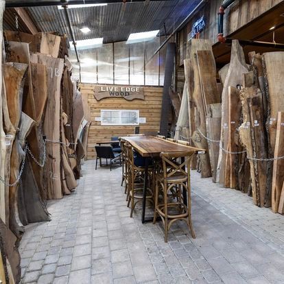 A room filled with lots of wooden pieces and a table and chairs.