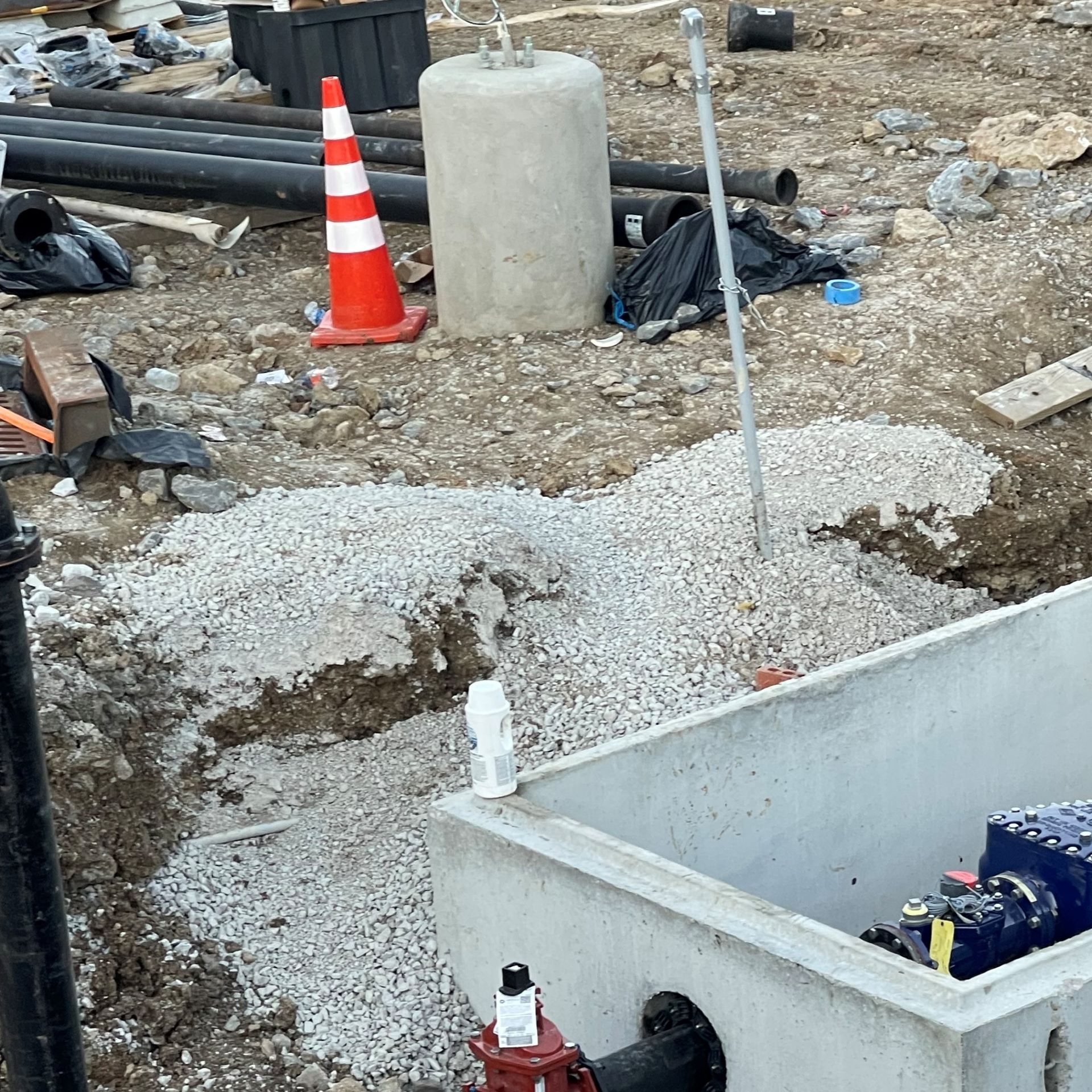 A construction site with a concrete box and a fire hydrant.