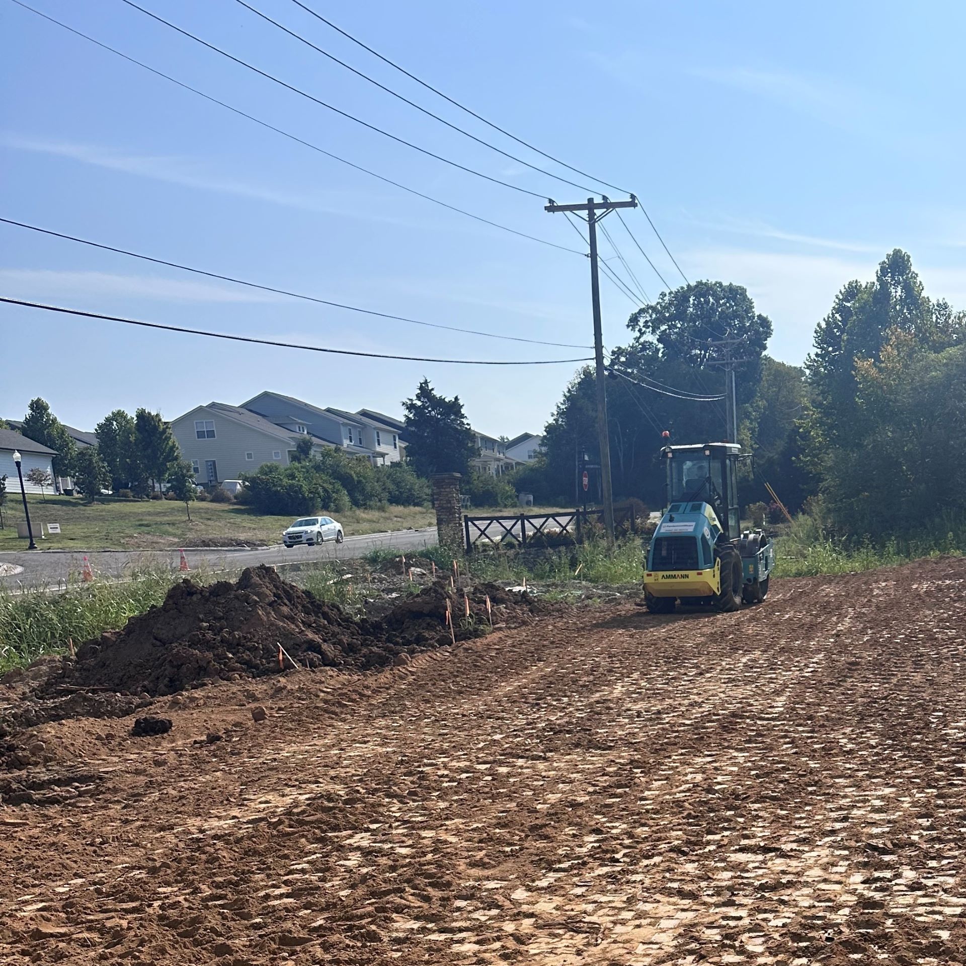 A yellow tractor is driving through a dirt field