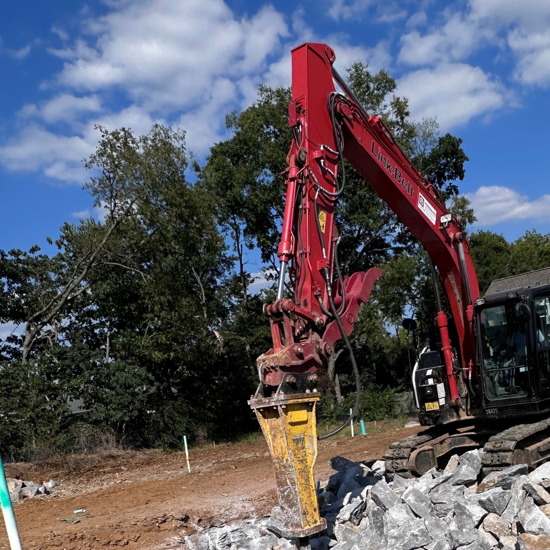 A red excavator with the word volvo on it