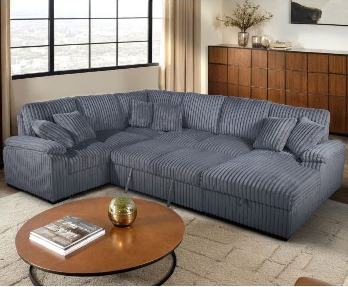 A living room with a large sectional couch and a coffee table