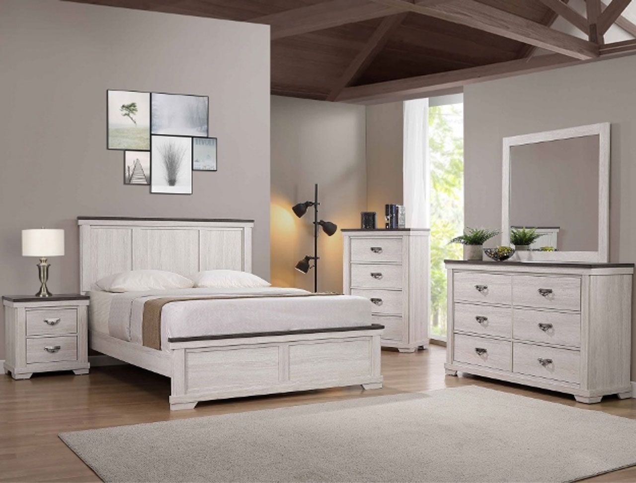A bedroom with a bed , dresser , nightstand , mirror and rug.
