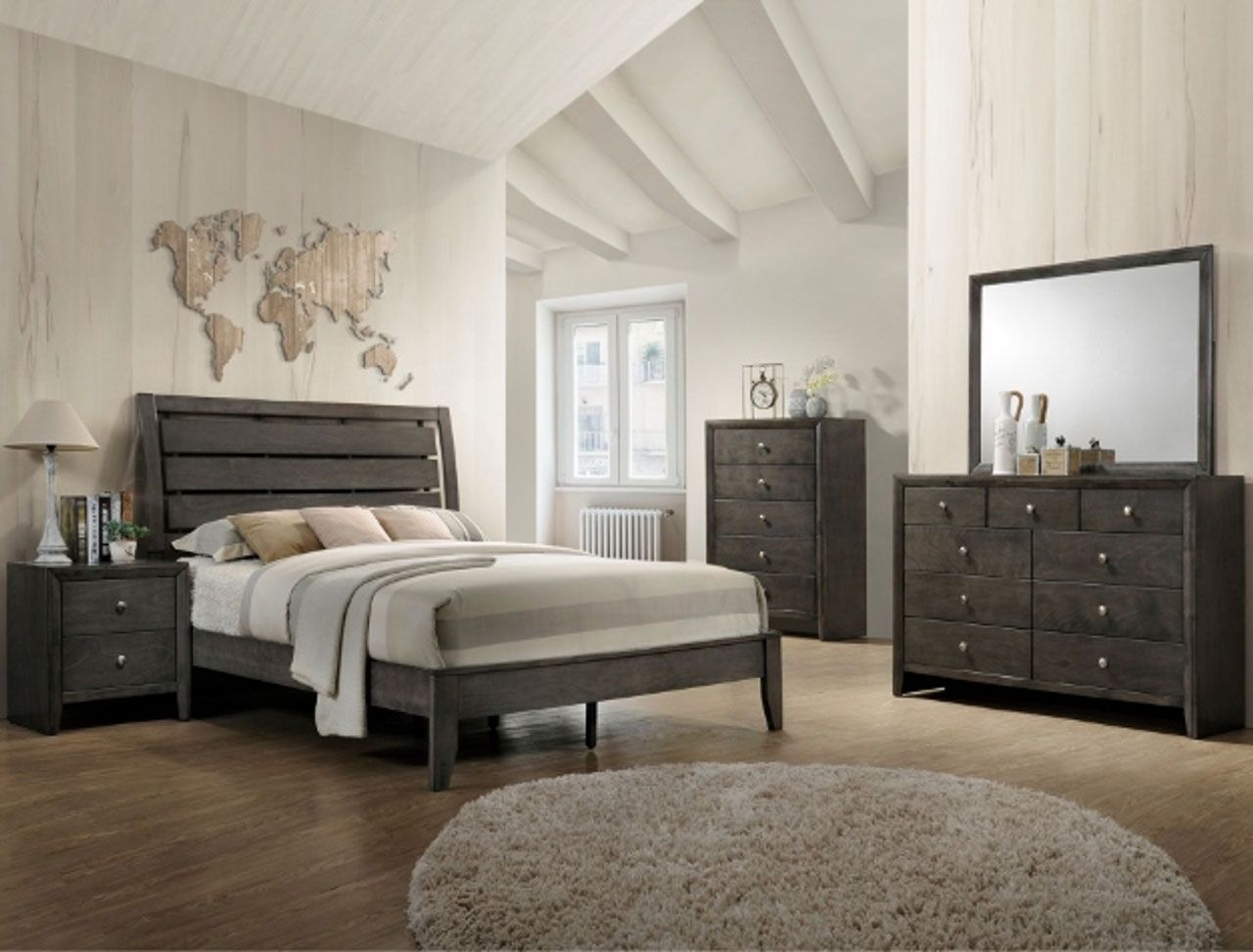A bedroom with a bed , dresser , nightstand and mirror.
