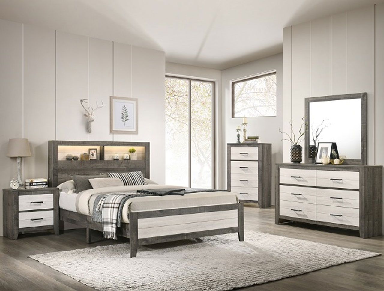 A bedroom with a bed , dresser , nightstand , mirror and rug.