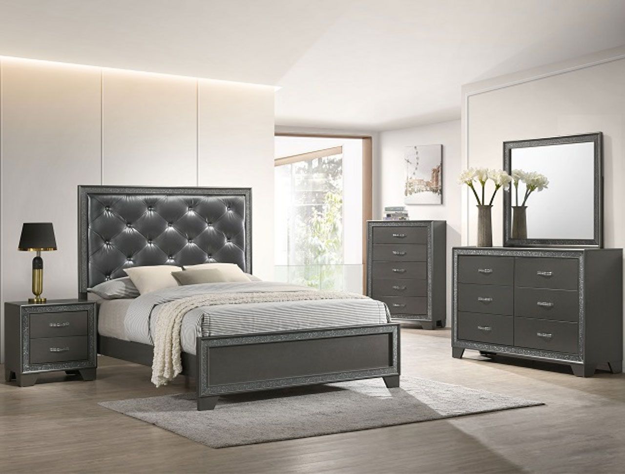 A bedroom with a bed , dresser , nightstand , mirror and lamp.
