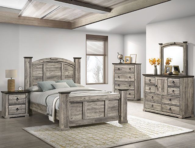 A bedroom with a bed , dresser , nightstand , mirror and rug.