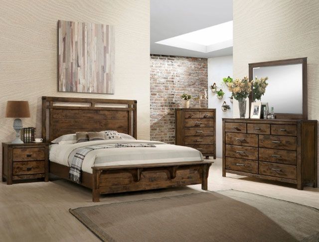 A bedroom with a bed , dresser , nightstand and mirror
