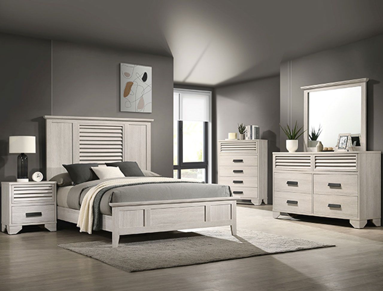 A bedroom with a bed , dresser , nightstand and mirror.
