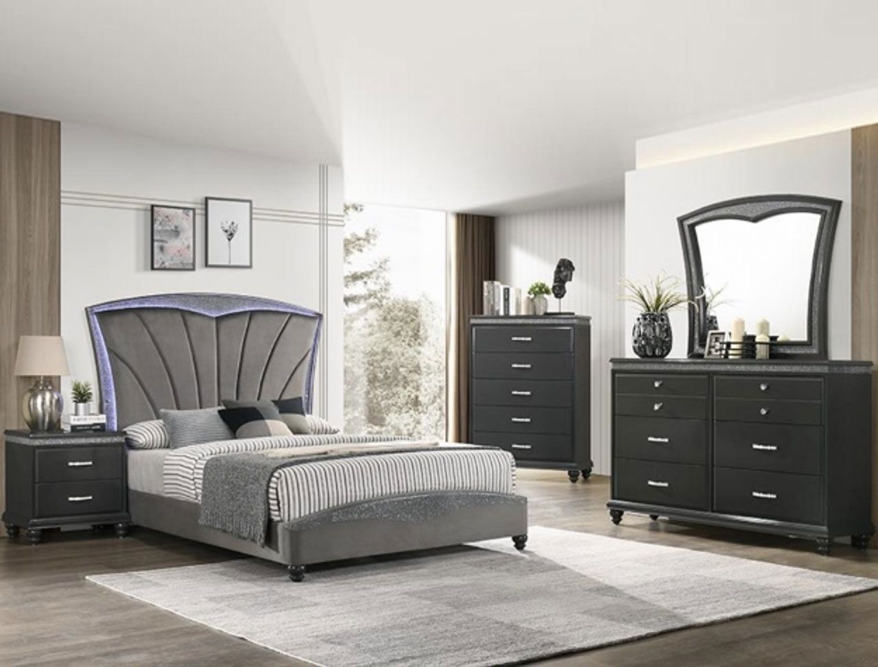 A bedroom with a bed , dresser , nightstand , mirror and rug.