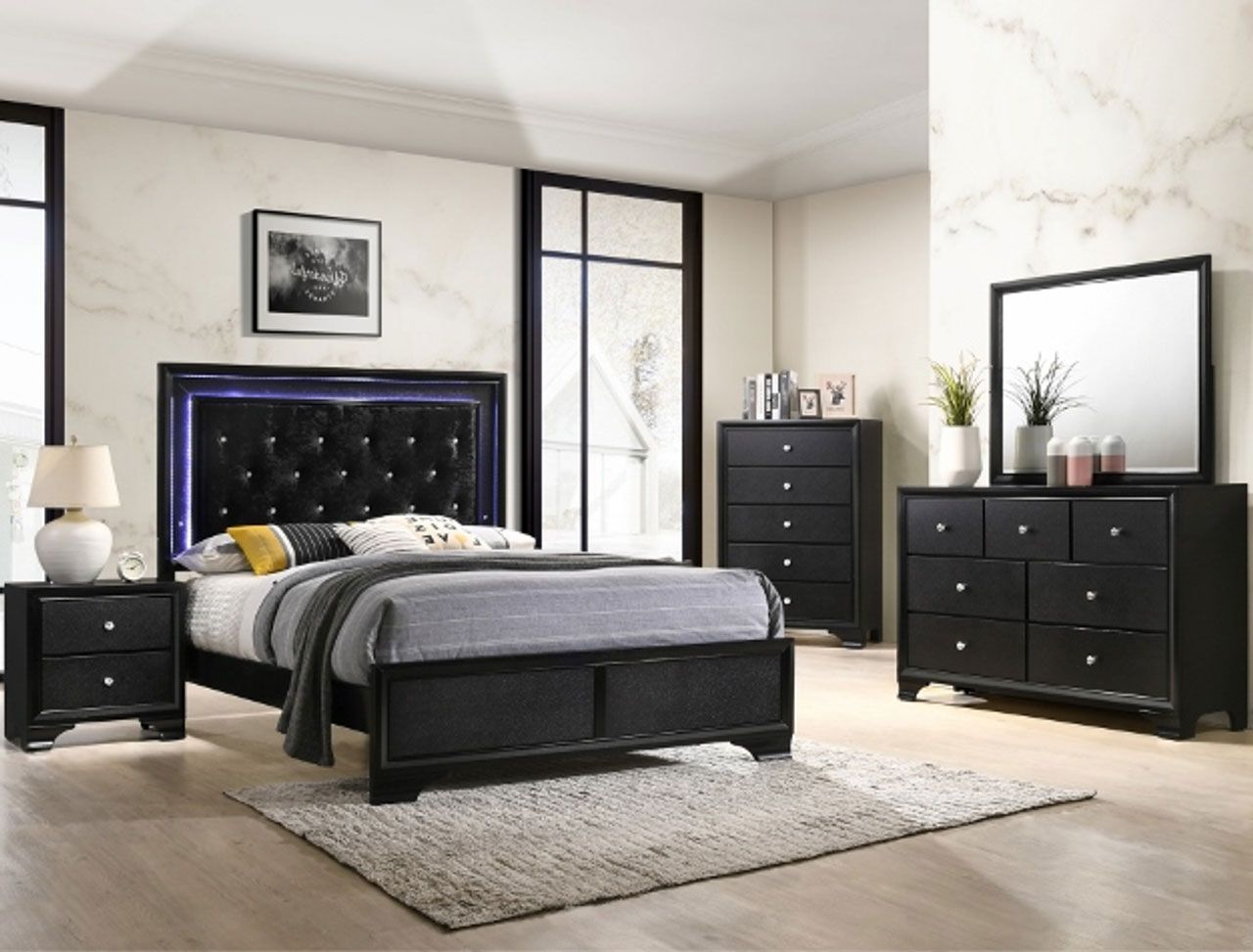 A bedroom with a bed , dresser , nightstand , mirror and rug.